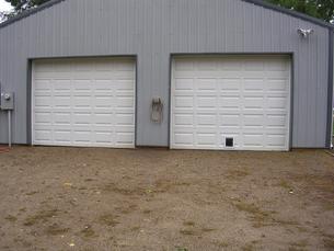 Garage east wall, north door with double insulated pet door.